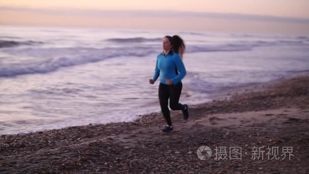 健身妇女赛跑者跑在海滩上视频