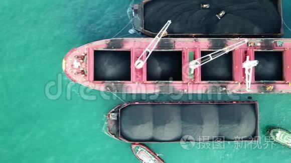 大型红母船/在海上货运港散装船上装载煤炭。 高空俯视图..
