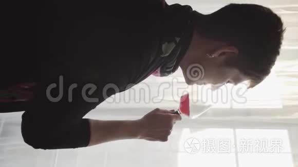 成熟的白种人黑发女人喝红酒，看着窗外的特写肖像。 优雅的退休人员或