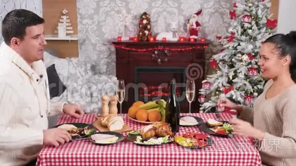 高加索夫妇在壁炉前享用圣诞晚餐