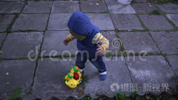 穿背心的孩子在街上的瓷砖上爬视频