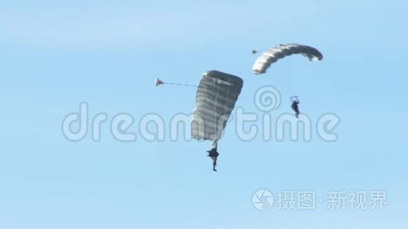 一支伞兵部队在蓝天的背景下登陆完成任务