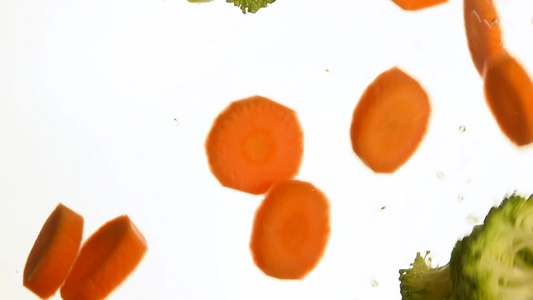 紧闭西兰花和胡萝卜扔在水中漂浮视频