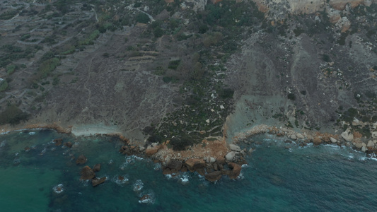 地中海岛屿美丽的海岸线蓝色海浪撞击岩石空中鸟眼倾斜视频