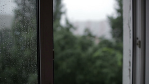 从窗户向大楼倾斜的重强雨点30秒视频