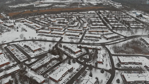 雪降后在城内街道和房屋上空飞行的空中风景30秒视频