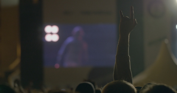 在户外音乐会大屏幕前展示摇滚魔鬼角的风光人举手姿势视频