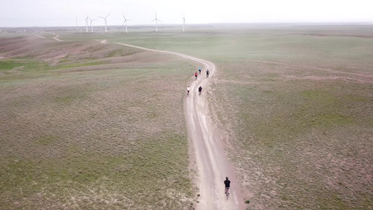 一群骑自行车的人沿风车行驶视频