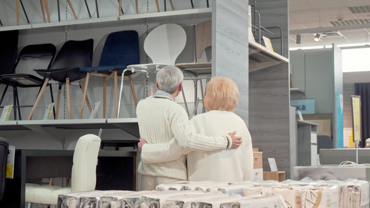 可爱的老年夫妇在商店一起选择家具视频