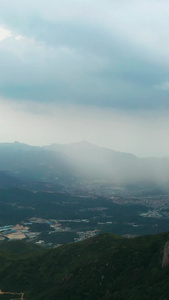 航拍山顶上远处下雨视频