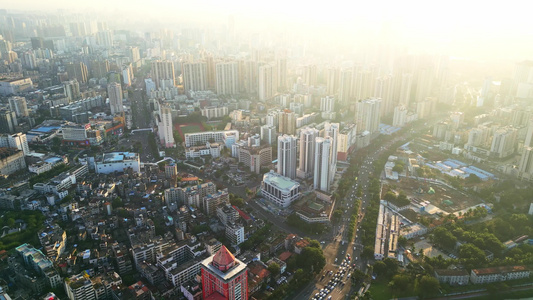 海南海口高视角航拍俯瞰金色阳光下城市交通建筑风景视频