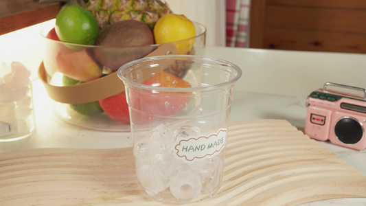 在玻璃杯里倒入冰块制作冷饮视频