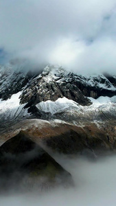 航拍云海之巅的雪山群山山峰自然风光视频