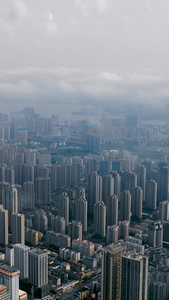 航拍平流雾云端之下的城市风光和建筑群天际线视频