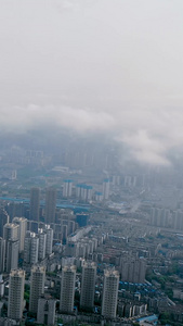 航拍平流雾云端之下的城市风光和建筑群市容市貌视频