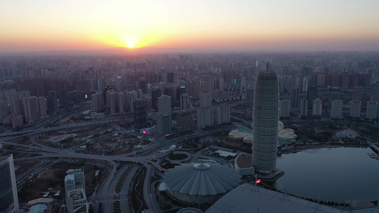 航拍郑州郑东新区CBD大玉米楼都市建筑群夕阳落日晚霞视频