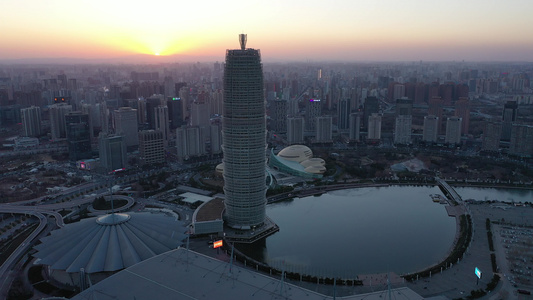 航拍郑州郑东新区CBD大玉米楼都市建筑群夕阳落日晚霞视频