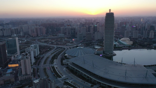 航拍郑州郑东新区CBD大玉米楼都市建筑群夕阳落日晚霞视频