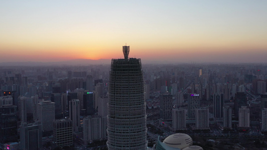 航拍郑州郑东新区CBD大玉米楼都市建筑群夕阳落日晚霞视频