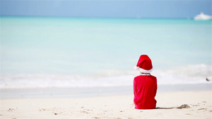 在白沙滩上穿着圣诞装的可爱女孩15秒视频