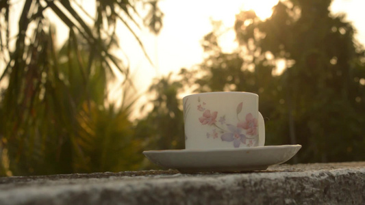 夕阳下的咖啡杯夏季清新凉爽的样子背景是散景城的一栋视频