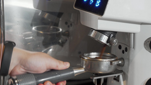 咖啡师在咖啡机中研磨咖啡的裁剪镜头13秒视频