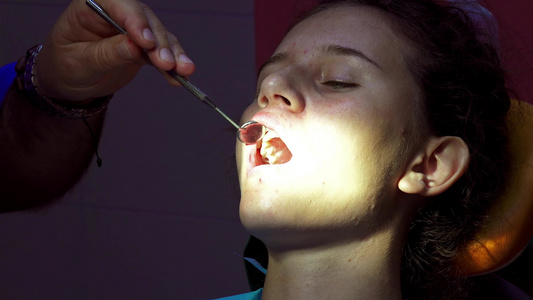 做牙医的小女孩用牙镜检查牙齿和牙镜视频