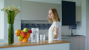 年轻妇女在厨房做燕麦粥女孩放瓶牛奶39秒视频