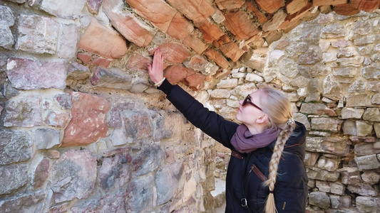 女孩检查欧洲古老城堡的墙壁视频