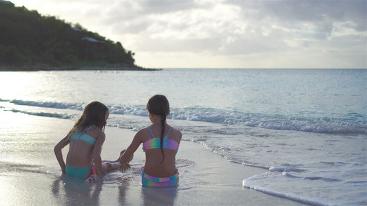 可爱的小姑娘们在海滩上玩沙子视频