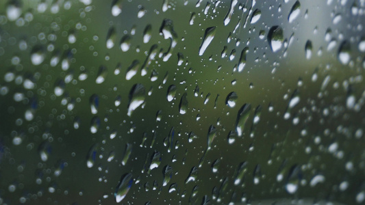 4K实拍春雨意境下雨天雨水打在车窗玻璃上雨滴特写视频