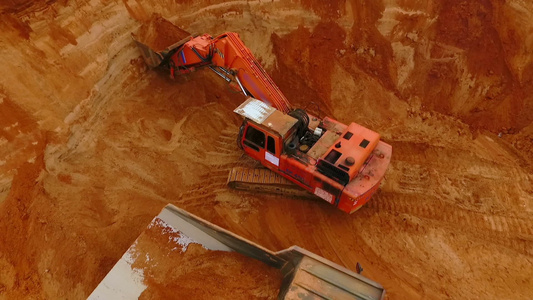 从上面看采矿挖土机在倾弃卡车上倒沙的情况视频