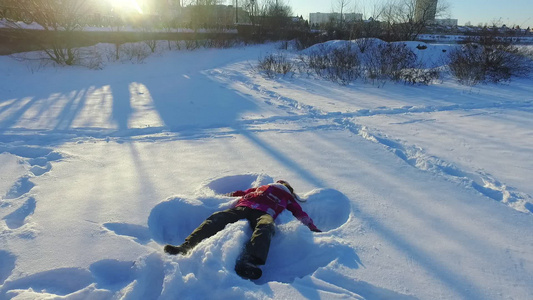 小女孩做雪天使冬季儿童节视频
