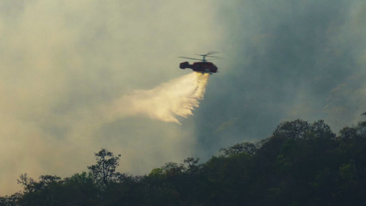 直升机在森林纵火时向森林浇水视频