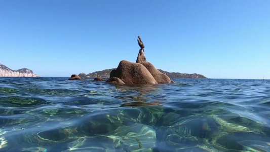 直射在清海和蓝天空中间的花岗岩上视频