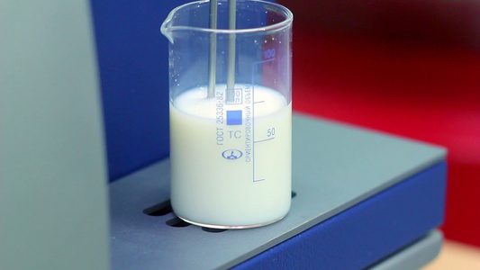 生物学家在实验室设备中用液态水杯进行测量视频