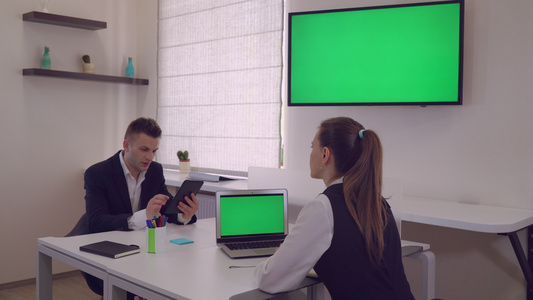 两个商业伙伴坐在现代办公室的办公桌前视频