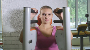 在健身房对年轻女子进行体重运动机培训20秒视频