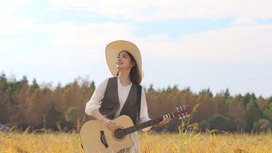 美女在稻田里开心弹吉他视频