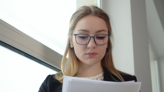 戴眼镜带文件工作的年轻女青年集中商业女商人视频