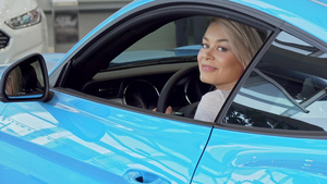 快乐的美丽的女人微笑坐在一辆新车上8秒视频