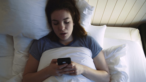 在床上使用手机的青年妇女27秒视频