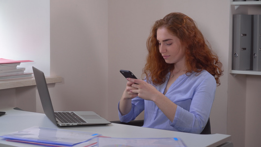 红发女性使用智能手机视频