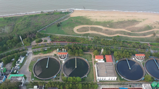 航拍海南海口海甸岛海边的白沙门污水处理厂视频