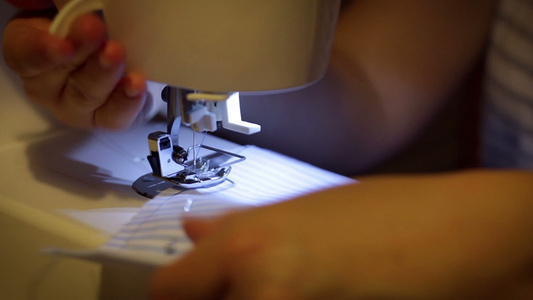 妇女在家里缝纫机上缝衣特写视频