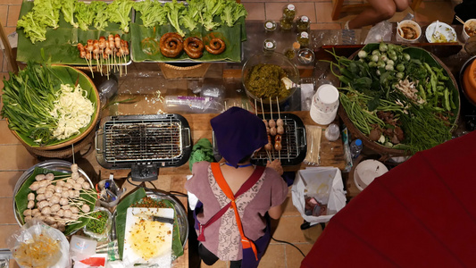 在亚洲美食广场卖食物的匿名妇女面目全非的女卖家站在视频