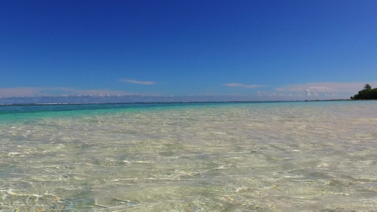 浅水和靠近波浪的白色沙滩背景的豪华度假村海滩度假的视频