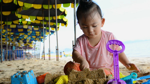 可爱的亚洲女婴在海滩玩沙滩玩具16秒视频