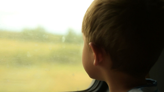 小孩从火车窗口看车窗视频