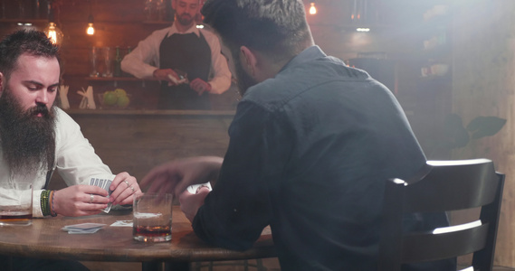 从右向左滑动在酒吧打牌的两名青年男子视频